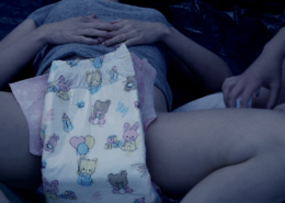 Close-up of Olivia changing Alisha's diaper.