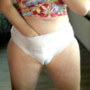 Lola rubs herself in her pull-on style diaper.